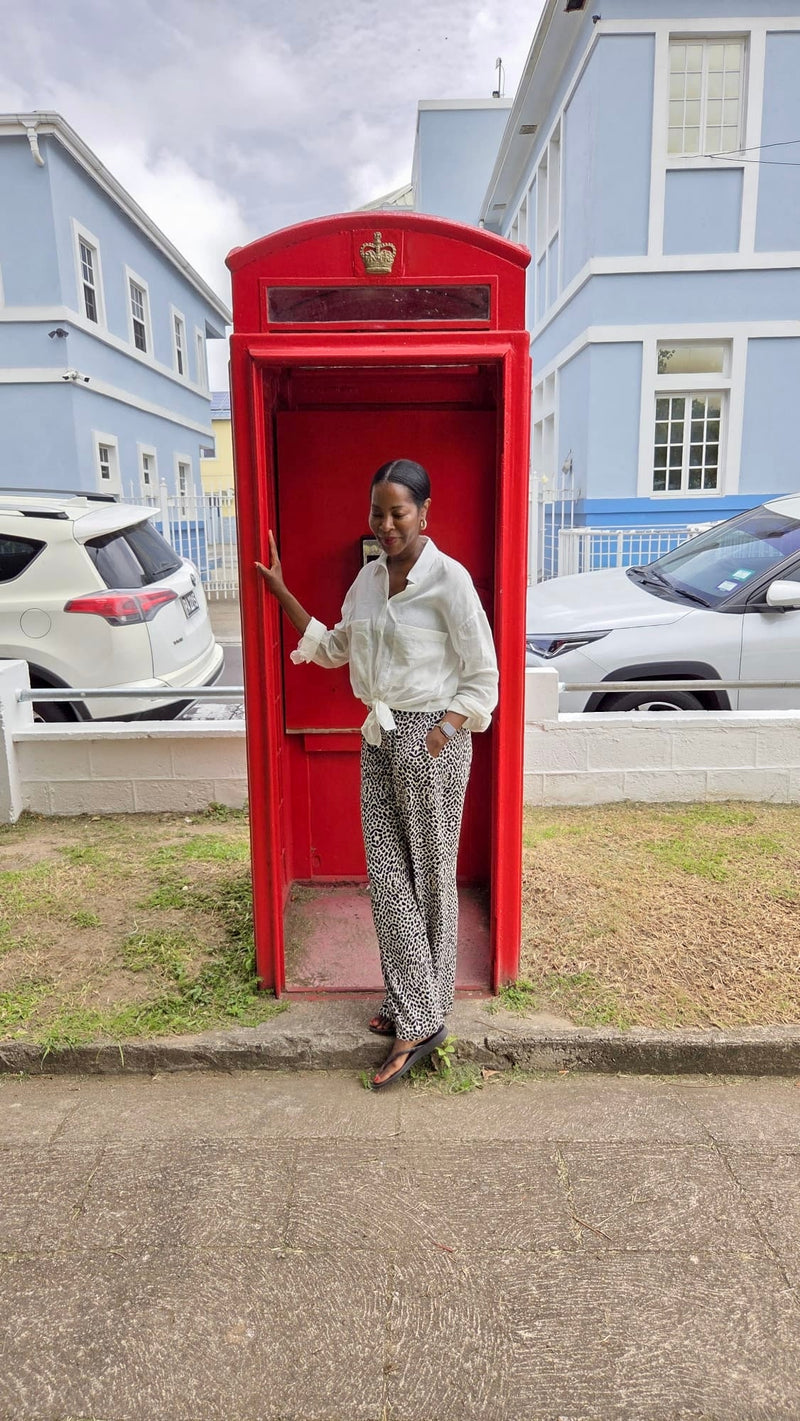 Founder standing by red telelphone box on the island of St Kitts
