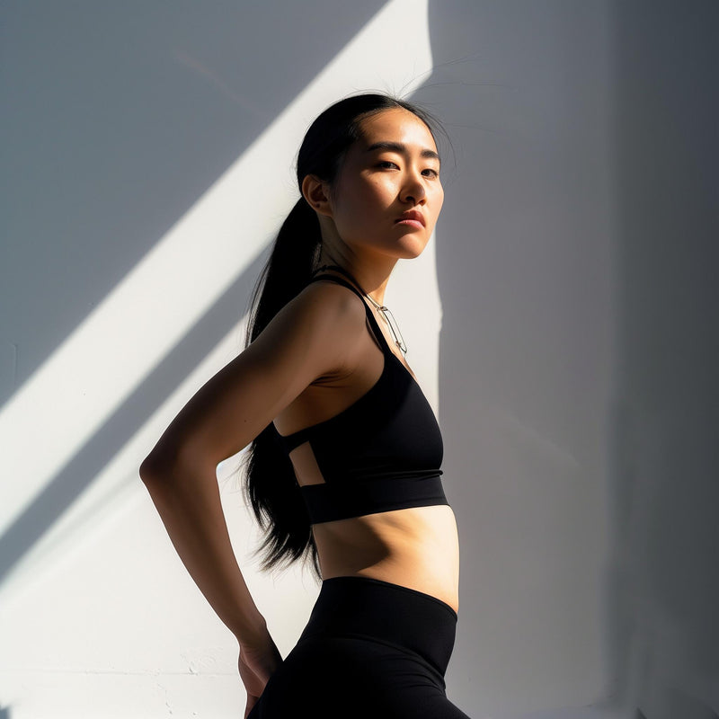 Woman in her 40s doing morning stretches by a window
